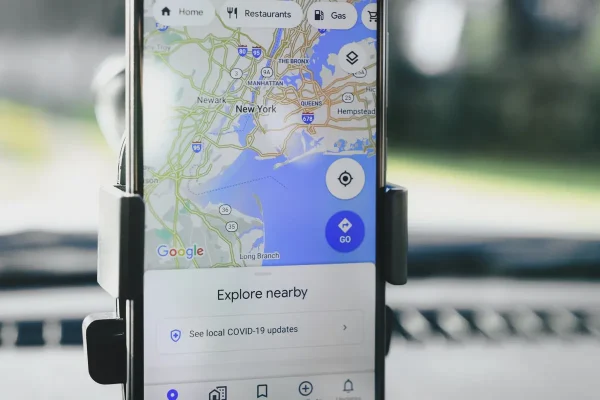 Smartphone displaying Google Maps with explore nearby panel, illustrating mobile local search results and map pack